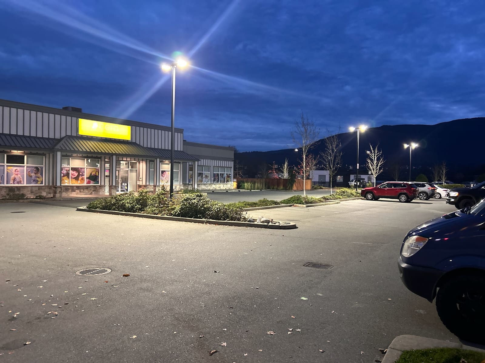 Commercial parking lot lighting installation lit up at night